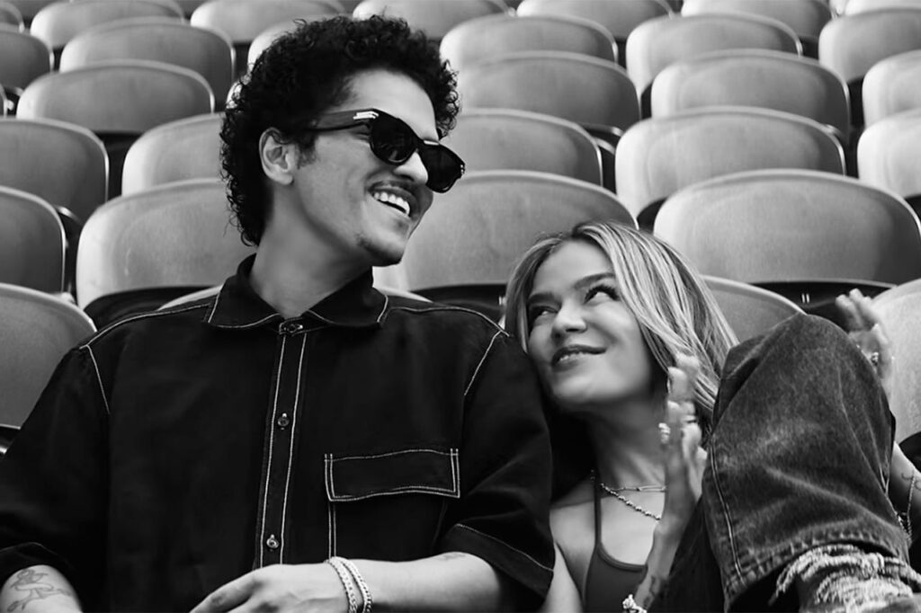 Karol G and Bruno Mars Drop Dreamy ‘Still’ Music Video Featuring Live Performance Clips