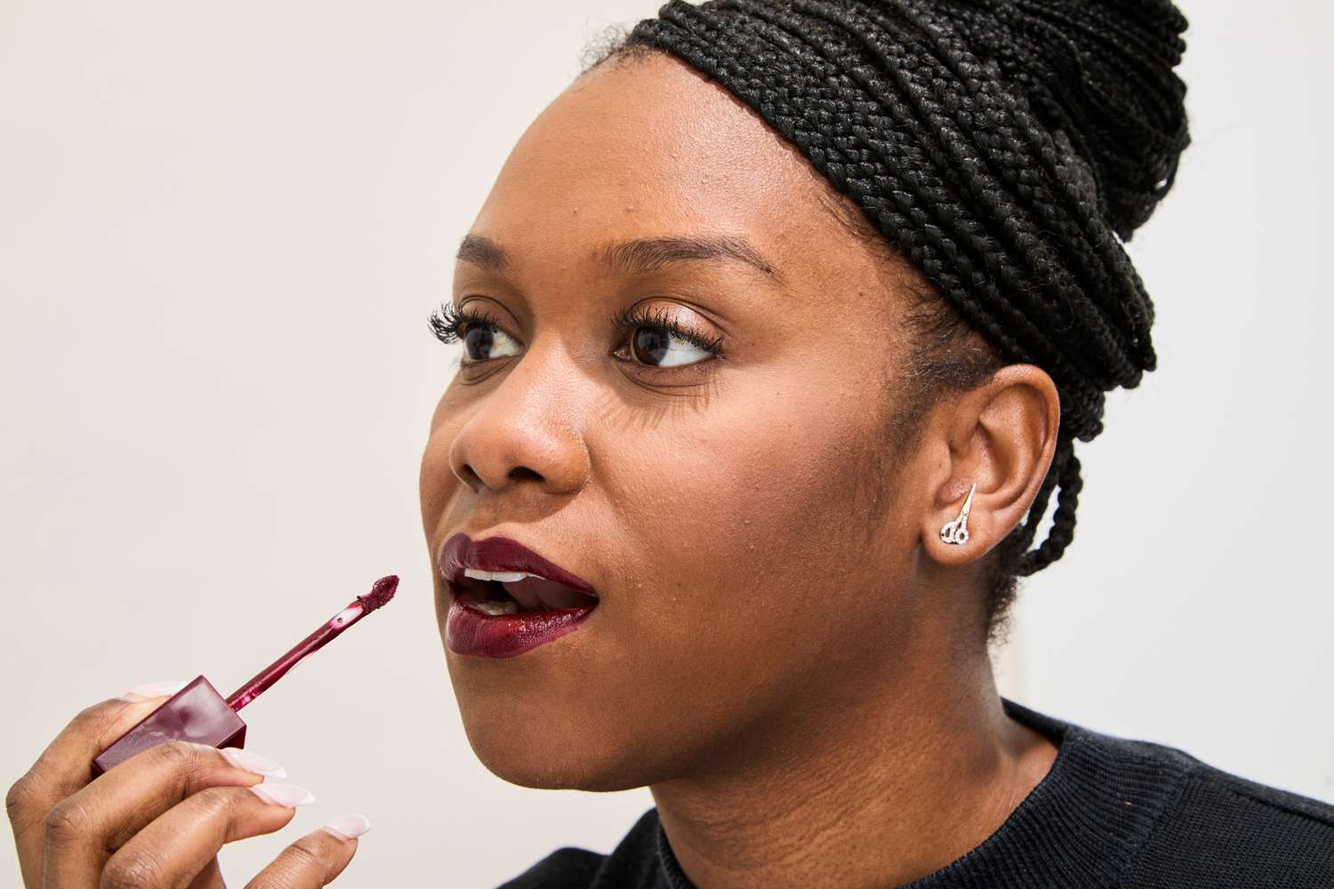 A person applies Revlon ColorStay Limitless Matte Liquid Lipstick