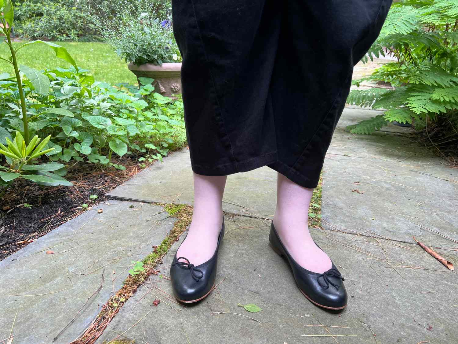 A person wears the Margaux The Demi Flats while walking outside
