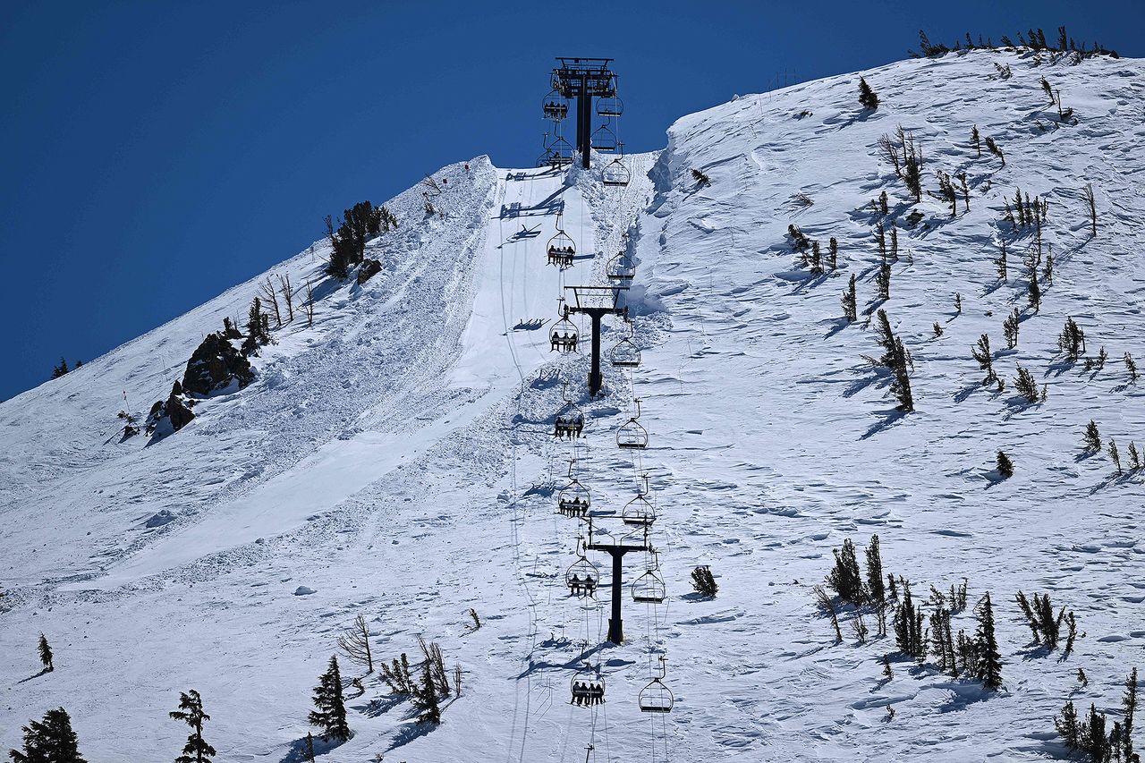Skiers and snowboarders ride a lift at the Mammoth Mountain in 2023 PATRICK T. FALLON/AFP via Getty