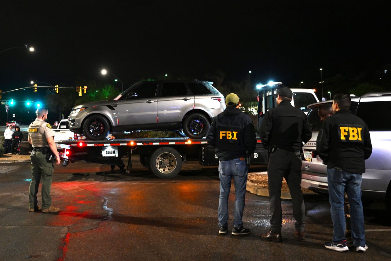FBI agents watch as a vehicle is towed from the parking lot of a restaurant in Tucson, Ariz., on Feb. 13, 2026 Brandon Bell/Getty 