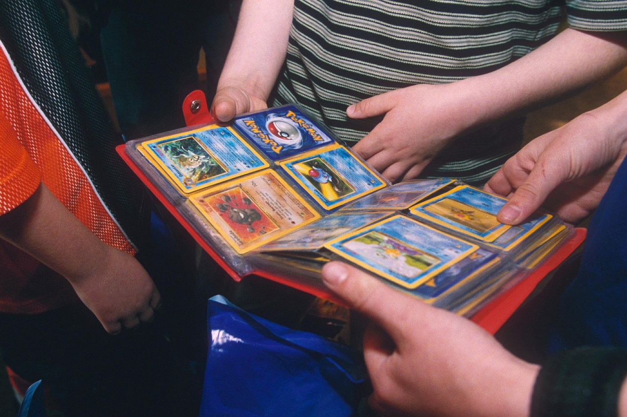 People look at a binder of Pokémon cardsCredit: Ray Tang/Shutterstock
