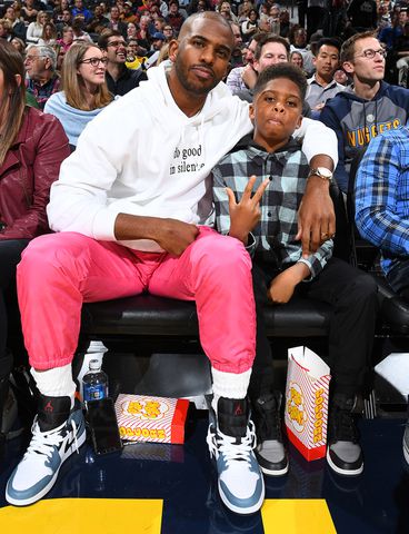 Chris Paul #3 of the Oklahoma City Thunder and Chris Paul Jr. watches the game on December 12, 2019 at the Pepsi Center in Denver, Colorado Chris Paul and son Chris Jr. Garrett Ellwood/NBAE via Getty