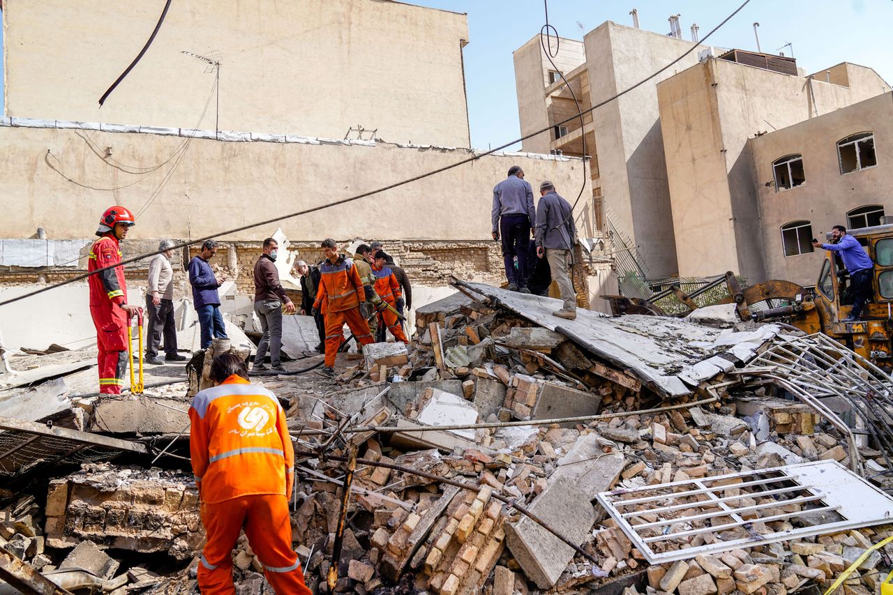Rescuers search through the rubble of a collapsed building at the site of a strike on a neighborhood in Tehran on Feb. 28, 2026.Credit: AMIR KHOLOUSI / ISNA / AFP via Getty