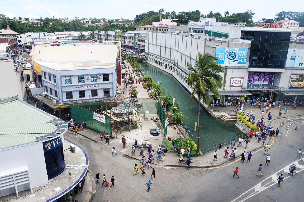 Aerial view of Suva city center, Fiji. Suva is the capital and second largest municipality and largest municipality with city status in Fiji. Fiji travel - Jan 2017 A busy street in the center of Fiji's capital, Suva. Chameleons Eye/Shutterstock