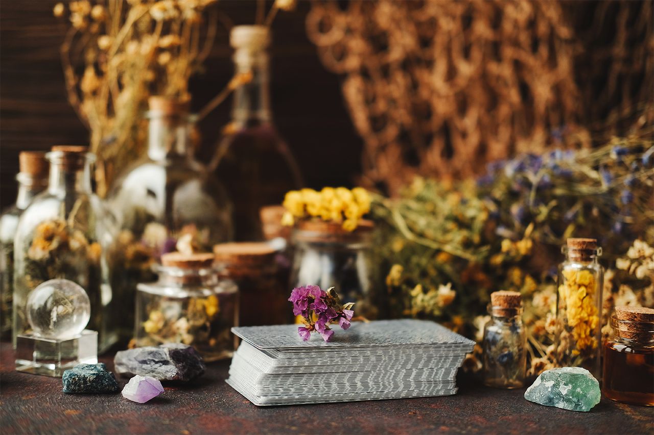 Stock photo of a tarot deck with crystals and dried herbs. Getty