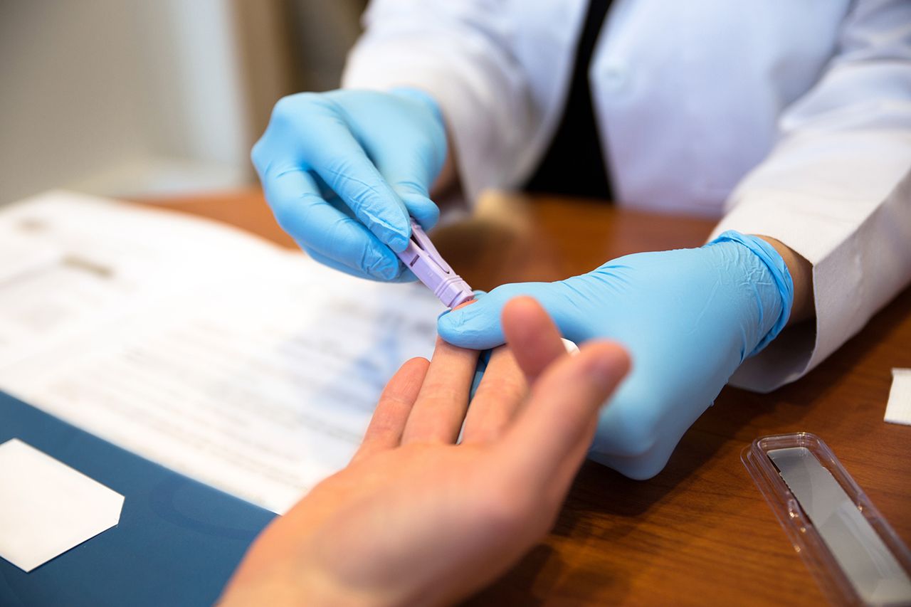 Doctor tests a patient for HIV AIDS. Stock image of a patient getting a test for HIV. Getty