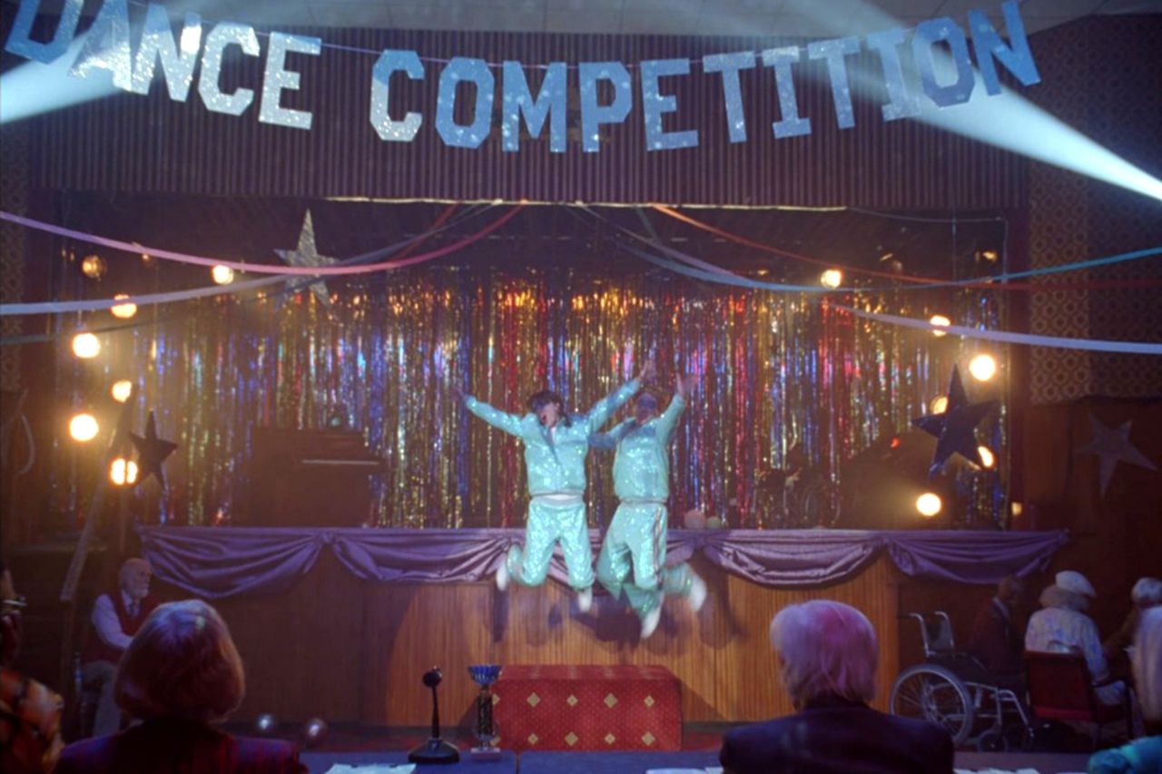 Domhnall Gleeson and Taylor Swift perform in front of the judges, including Barrie Reynolds, in the 'Opalite' music videoCredit: Taylor Swift/Youtube