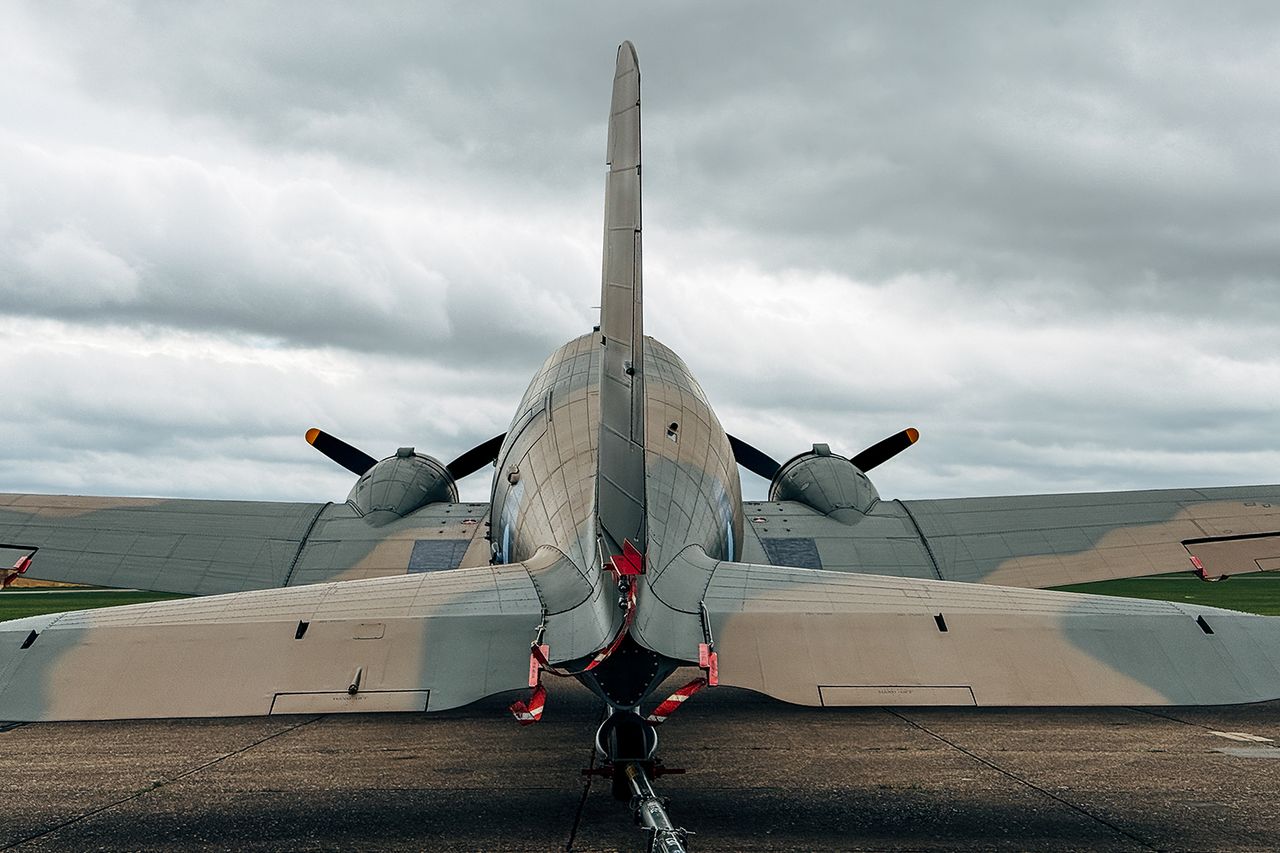 A rear view of a brown and green camouflaged vintage Douglas C-47 Douglas C-47 aircraft.Credit: Getty