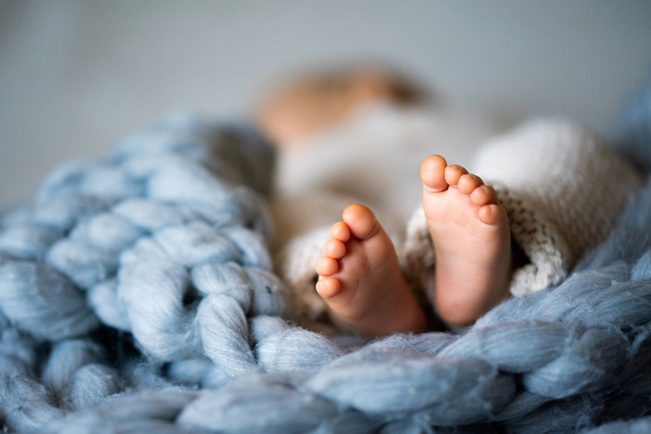 Foot of newborn baby on warm blanket Stock photo of a baby.Credit: Getty