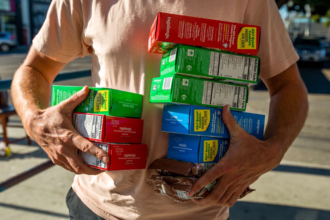 stock image of person holding boxes of Girl Scouts cookiesCredit: Francine Orr / Los Angeles Times via Getty Images