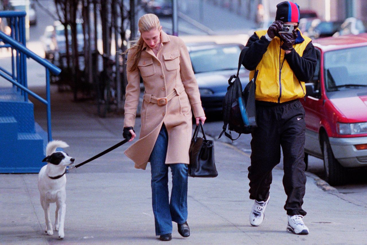 Carolyn Bessette Kennedy in her camel colored Prada coat with John F. Kennedy Jr. and their dog Friday.Credit: Lawrence Schwartzwald/Sygma via Getty