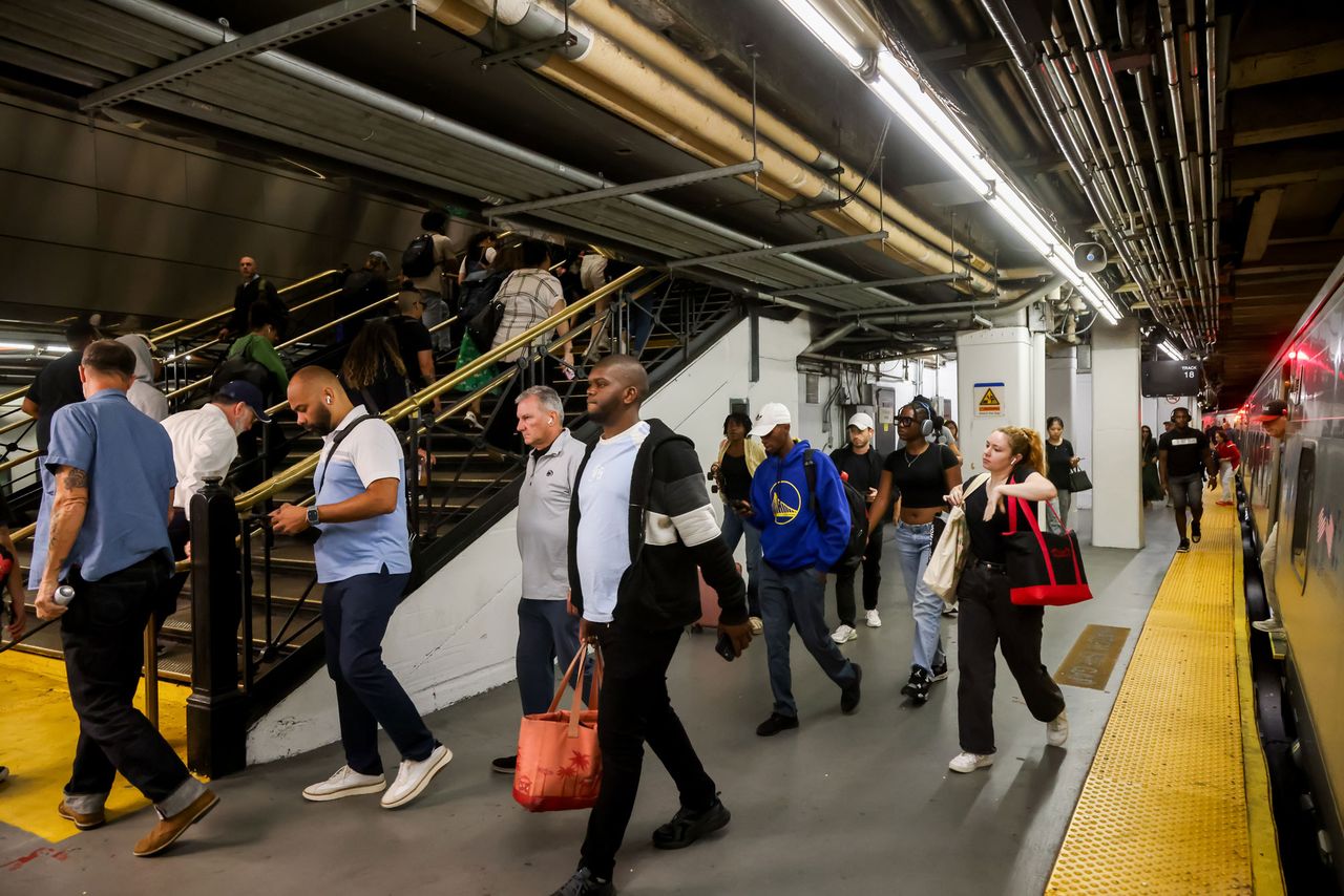 Commuters on a Long Island Rail Road (LIRR) train platform at Penn Station.Credit: Michael Nagle/Bloomberg via Getty