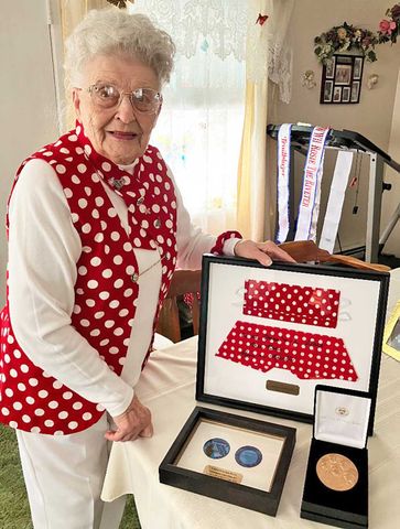 Mae Krier with the Congressional Medal and Rosie mask and bandana that went to space.Credit: Courtesy of Deb Woolson