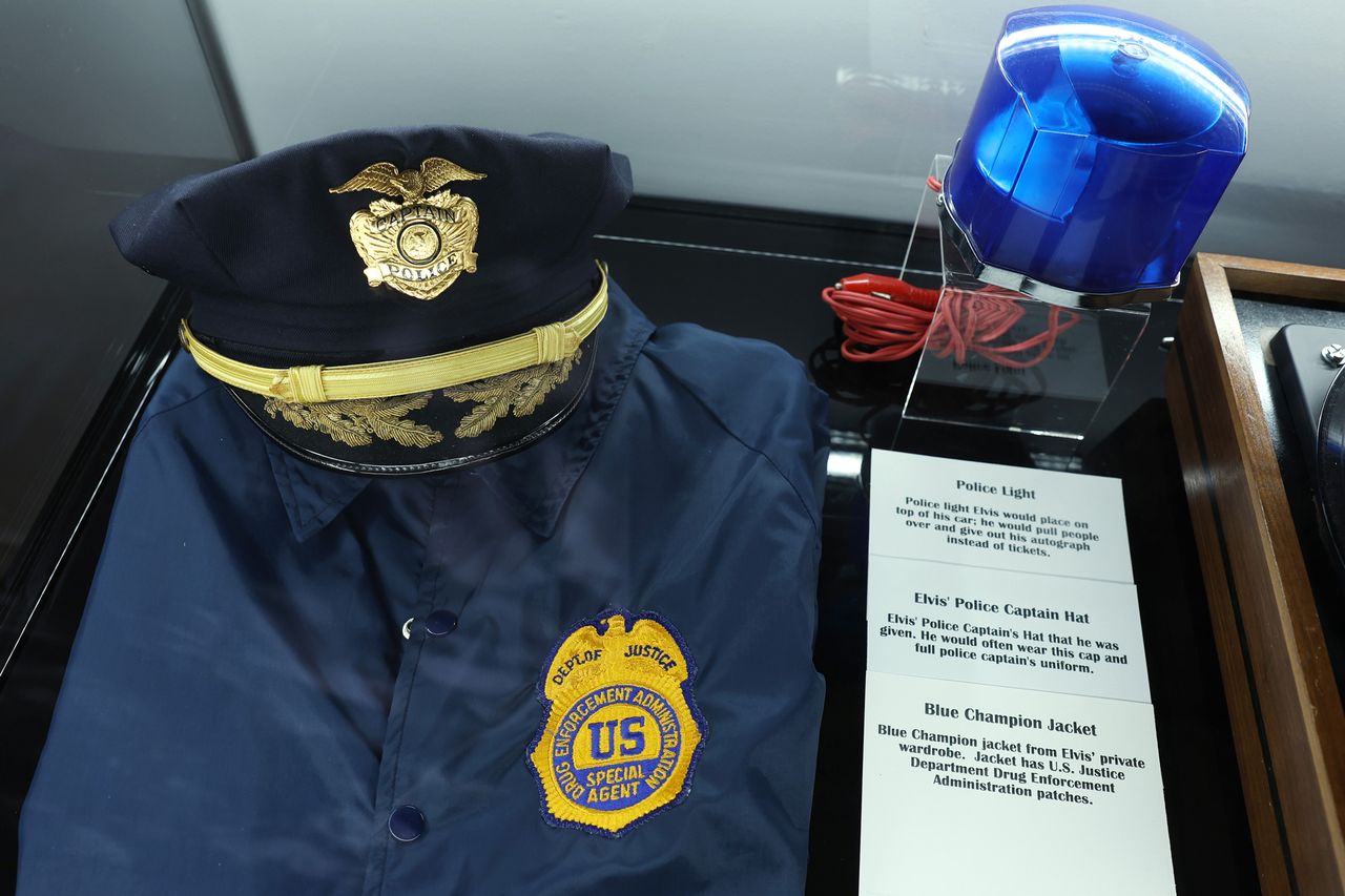Police uniform and badge owned by Elvis Presley Elvis Presley's police light, captain hat and champion jacketCredit: Lia Toby/Getty
