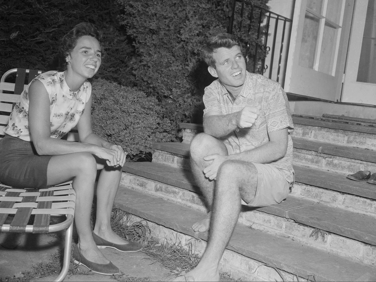 (Original Caption) Robert F. Kennedy and wife, Ethel Kennedy sit, talking. Ethel is seated on a lawn chair, holding a drink and RFK is sitting on a set of stone stairs. They are both casually dressed. Full length photograph. Robert F. Kennedy and his wife, Ethel KennedyCredit: Bettmann/Getty Images