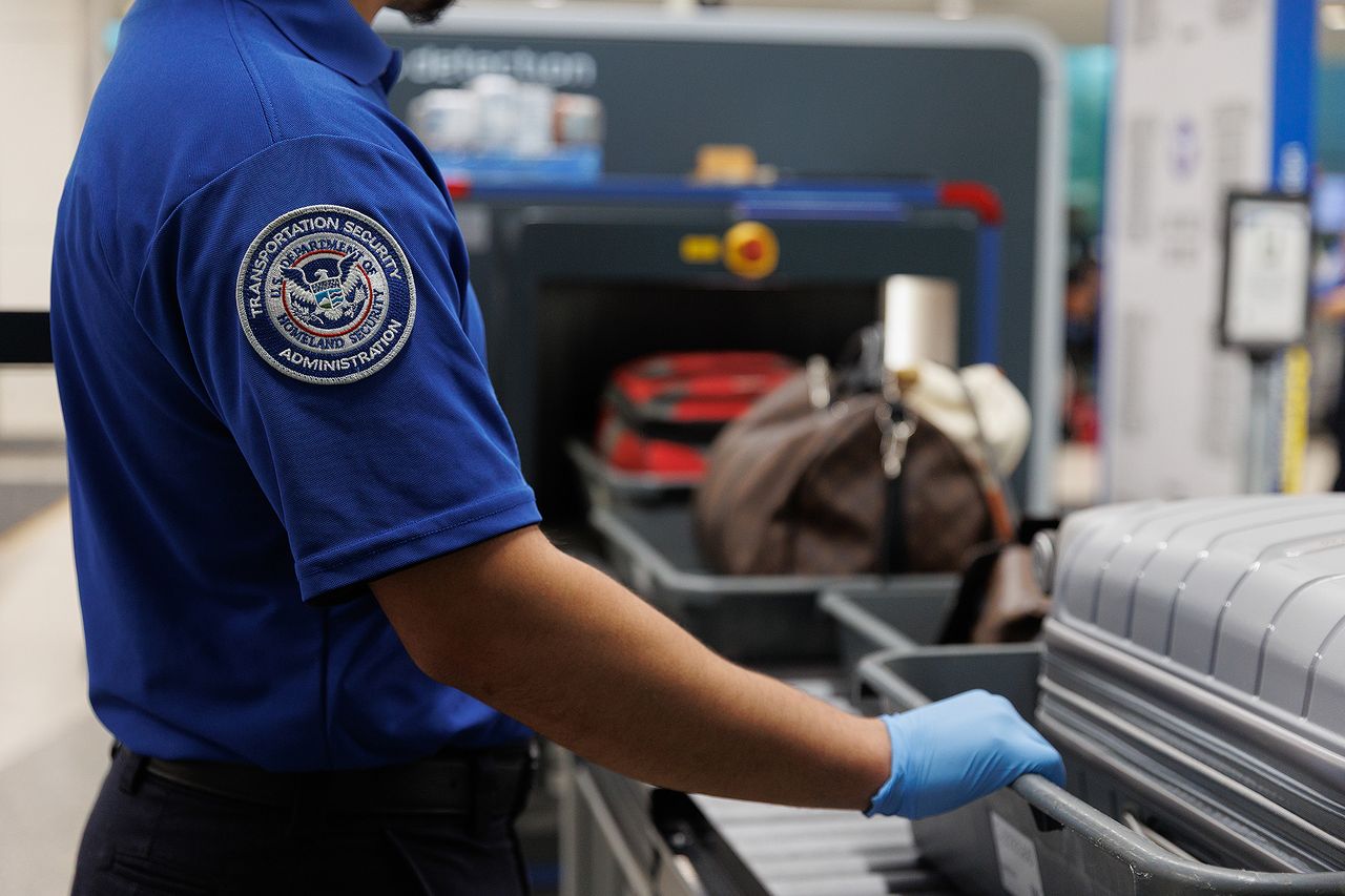 A TSA agent monitors travelers at Dallas Love Field AirportCredit: Shelby Tauber/Bloomberg via Getty