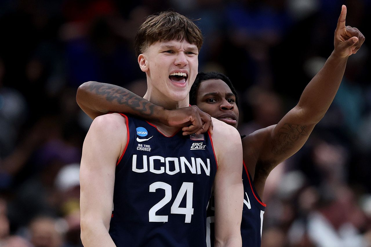 Braylon Mullins #24 celebrates with Malachi Smith #0 of the UConn Huskies after shooting the game-winning three point basket during the second half of a game against the Duke Blue Devils in the Elite Eight of the 2026 NCAA Men's Basketball Tournament.Credit: Patrick Smith/Getty