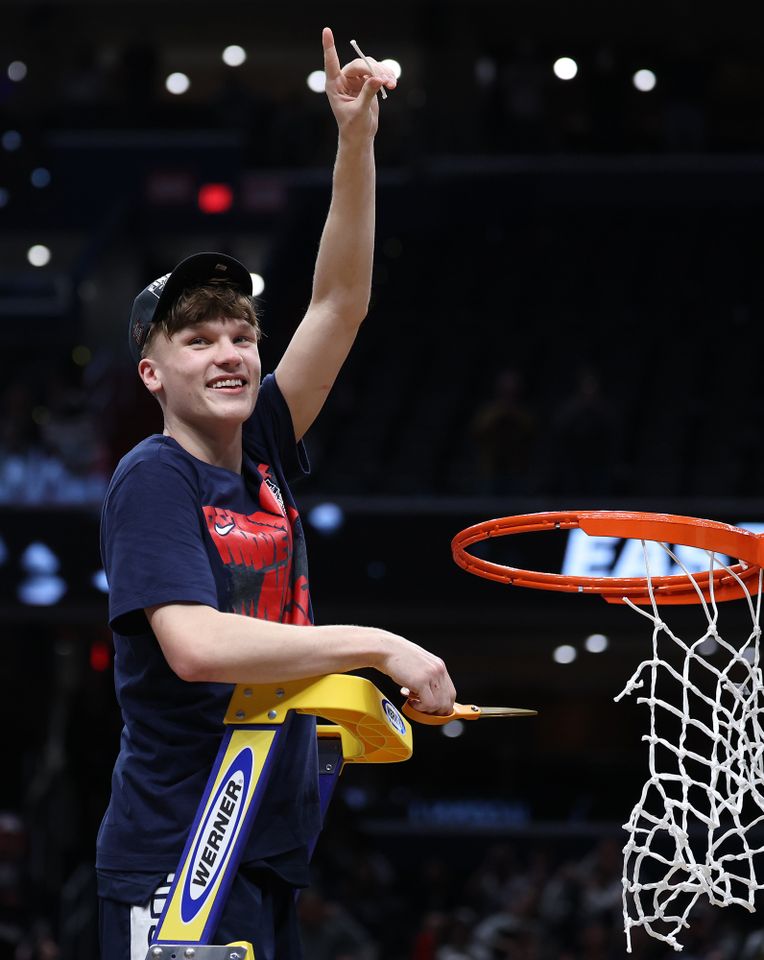 Braylon Mullins #24 of the UConn Huskies cuts down the net after defeating the Duke Blue Devils 73-72 in the Elite Eight of the 2026 NCAA Men's Basketball Tournament.Credit: Emilee Chinn/Getty