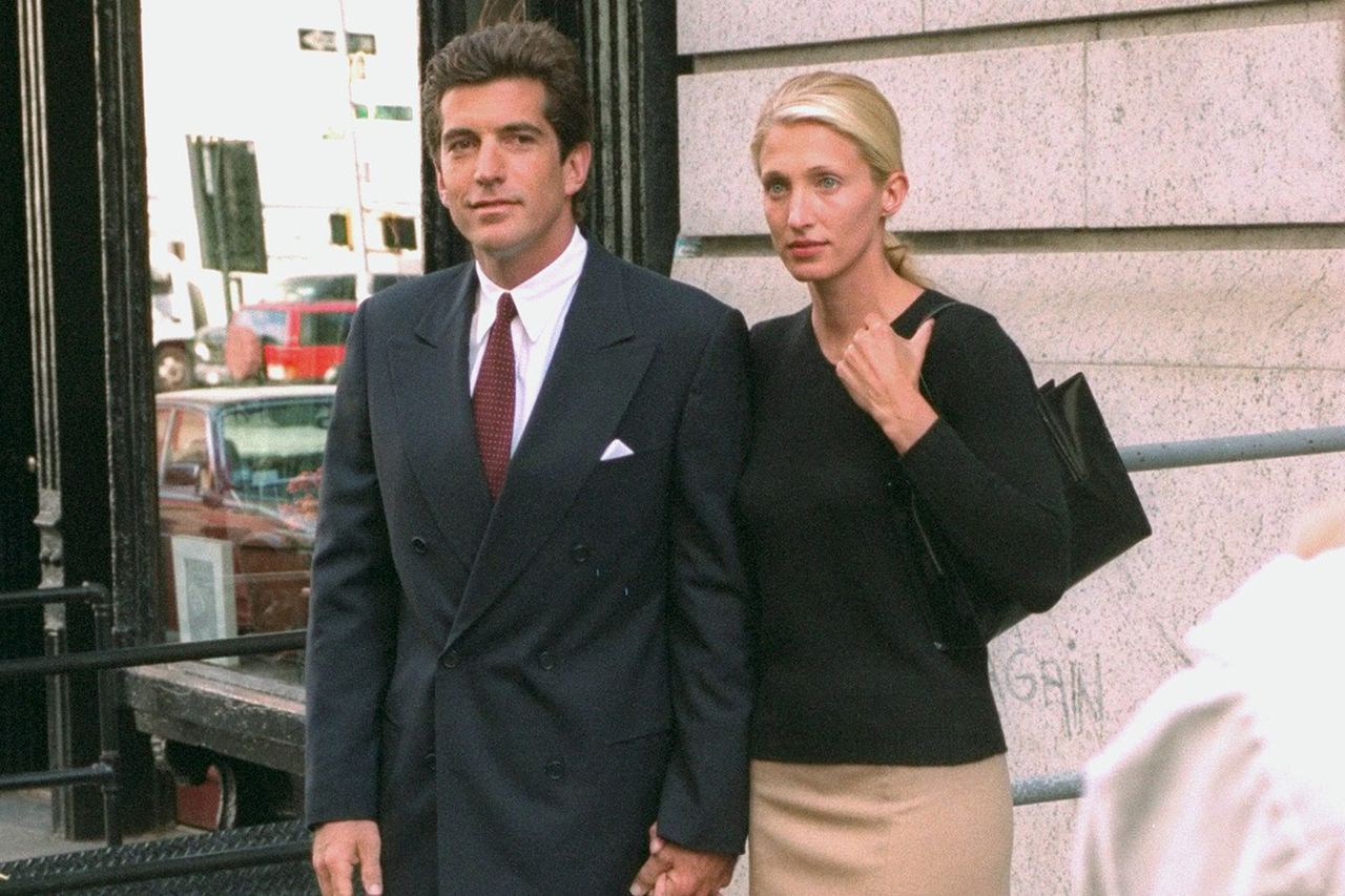 John F. Kennedy Jr. and Carolyn Bessette Kennedy stand in front of their apartment in New York City.Credit: Jon Naso/NY Daily News via Getty