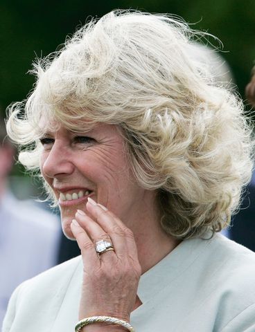Camilla the Duchess of Cornwall laughs after kissing her husband Prince Charles after polo at Cirencester on June 17, 2005 in Cirencester, England.Credit: Tim Graham Photo Library via Getty