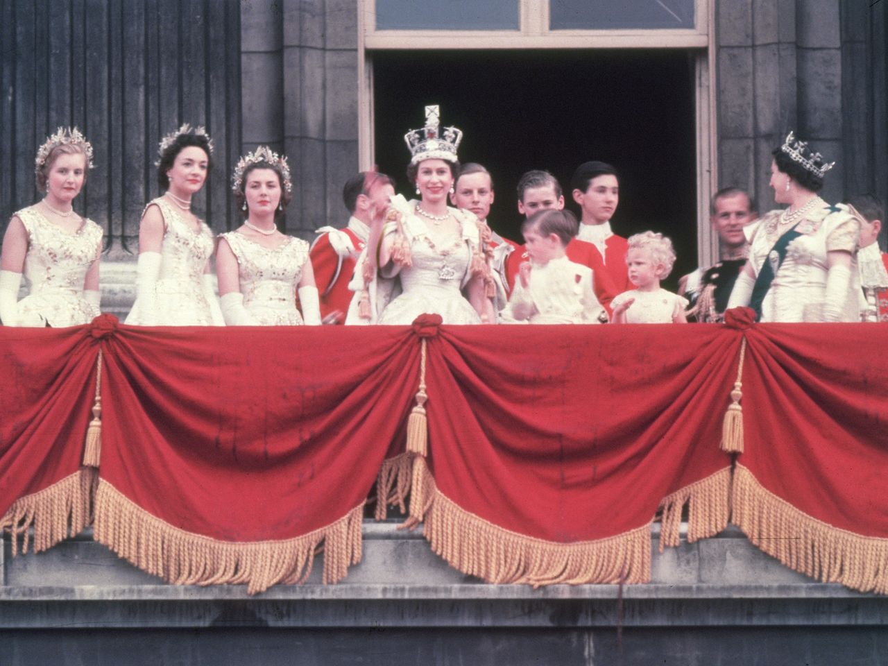 The newly crowned Queen Elizabeth waves to the crowd from the balcony at Buckingham Palace The newly crowned Queen Elizabeth waves to the crowd from the balcony at Buckingham PalaceCredit: Hulton Archive/Getty