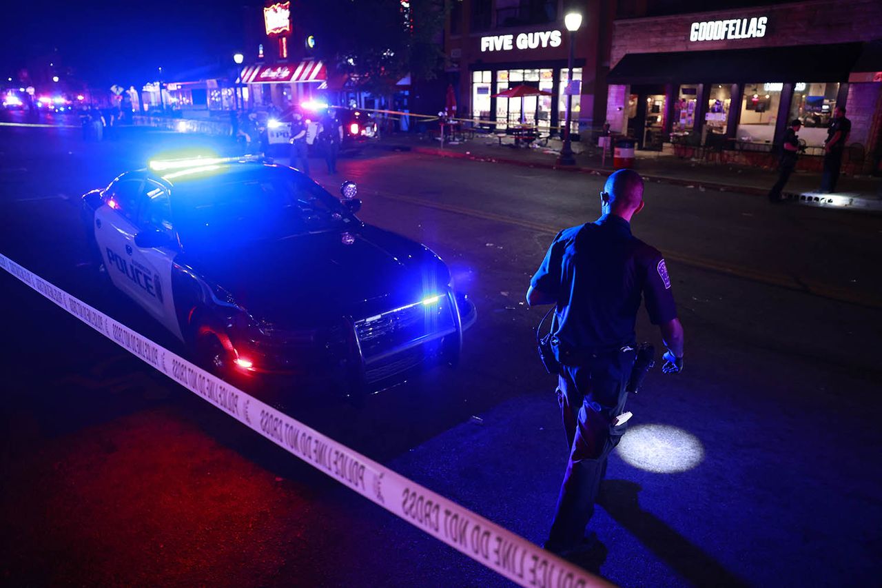 Police officers investigate the scene following a shooting on Kirkwood AvenueCredit: Jeremy Hogan/Getty