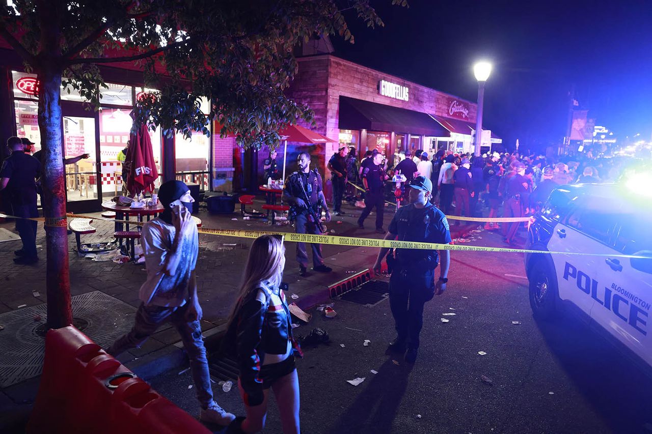 Police officers cordon off the scene during an investigation following a shooting on Kirkwood AvenueCredit: Jeremy Hogan/Getty