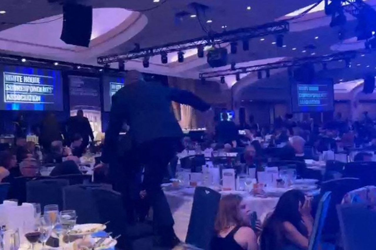Agents climb over tables to respond after shots were fired at the White House Correspondents' Dinner on April 25, 2026Credit: Danny KEMP and AFPTV teams / AFP via Getty