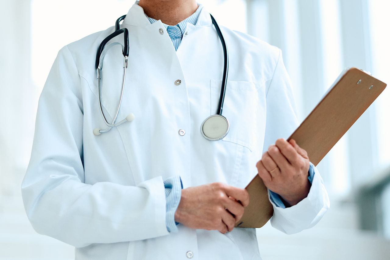 Asian female doctor holding clipboard smiling in clinic corridor - stock photo A stock photo of a doctor with a clipboardCredit: Getty