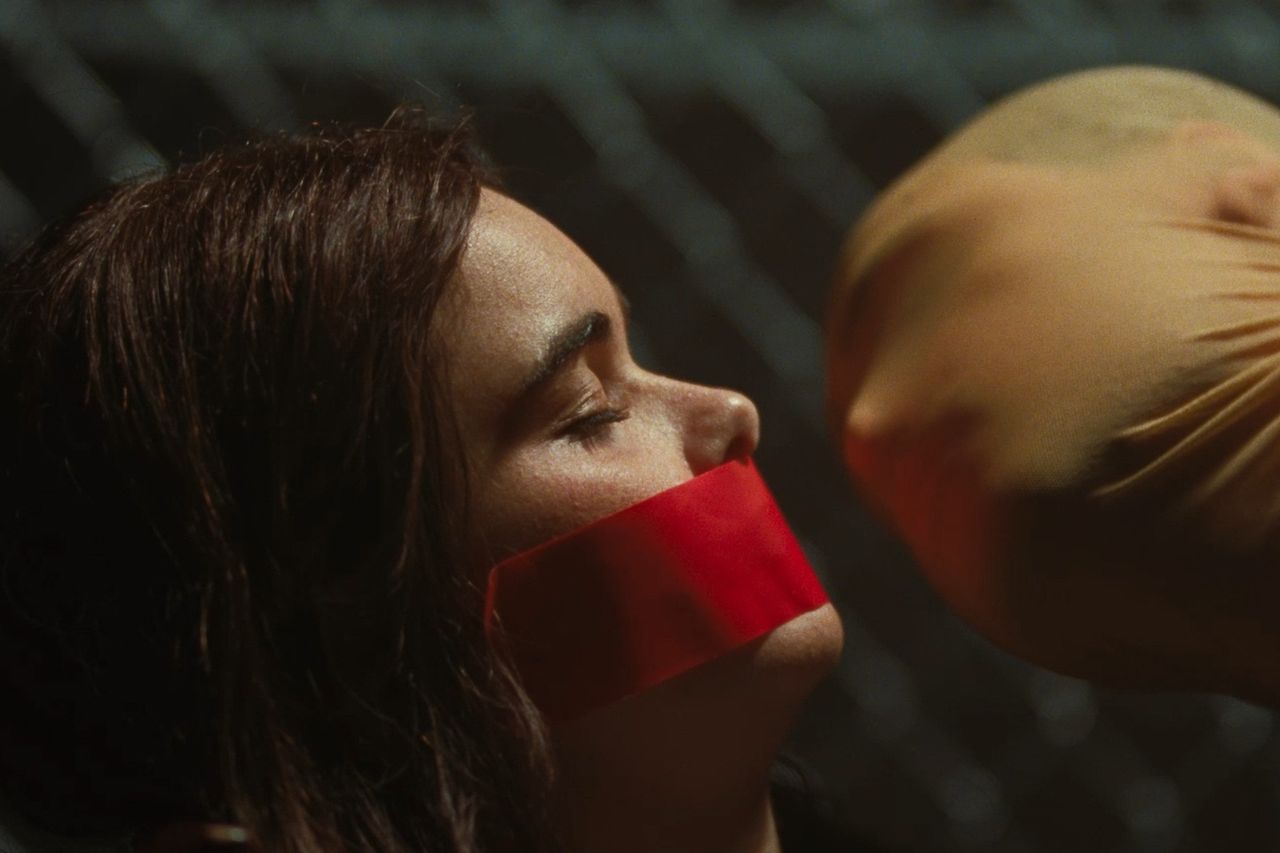 Barbie Ferreira with red tape over her mouth and a gloved hand nearby Dacre Montgomery in 'Faces of Death'Credit: Courtesy of Independent Film Company and Shudder