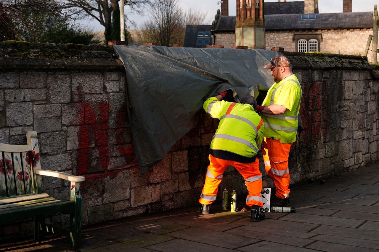 Workers start to clean off the spray painted graffiti which says Not My King on the wall outside St Asaph Cathedral in North Wales, where King Charles III and Queen Camilla will attend the Royal Maundy Service later today. It is the first time the Royal Maundy Service has been held in Wales since 1982 and only the second time in its history Workers clean off spray painted graffiti on the wall outside St Asaph Cathedral on April 2, 2026.Credit: Alamy