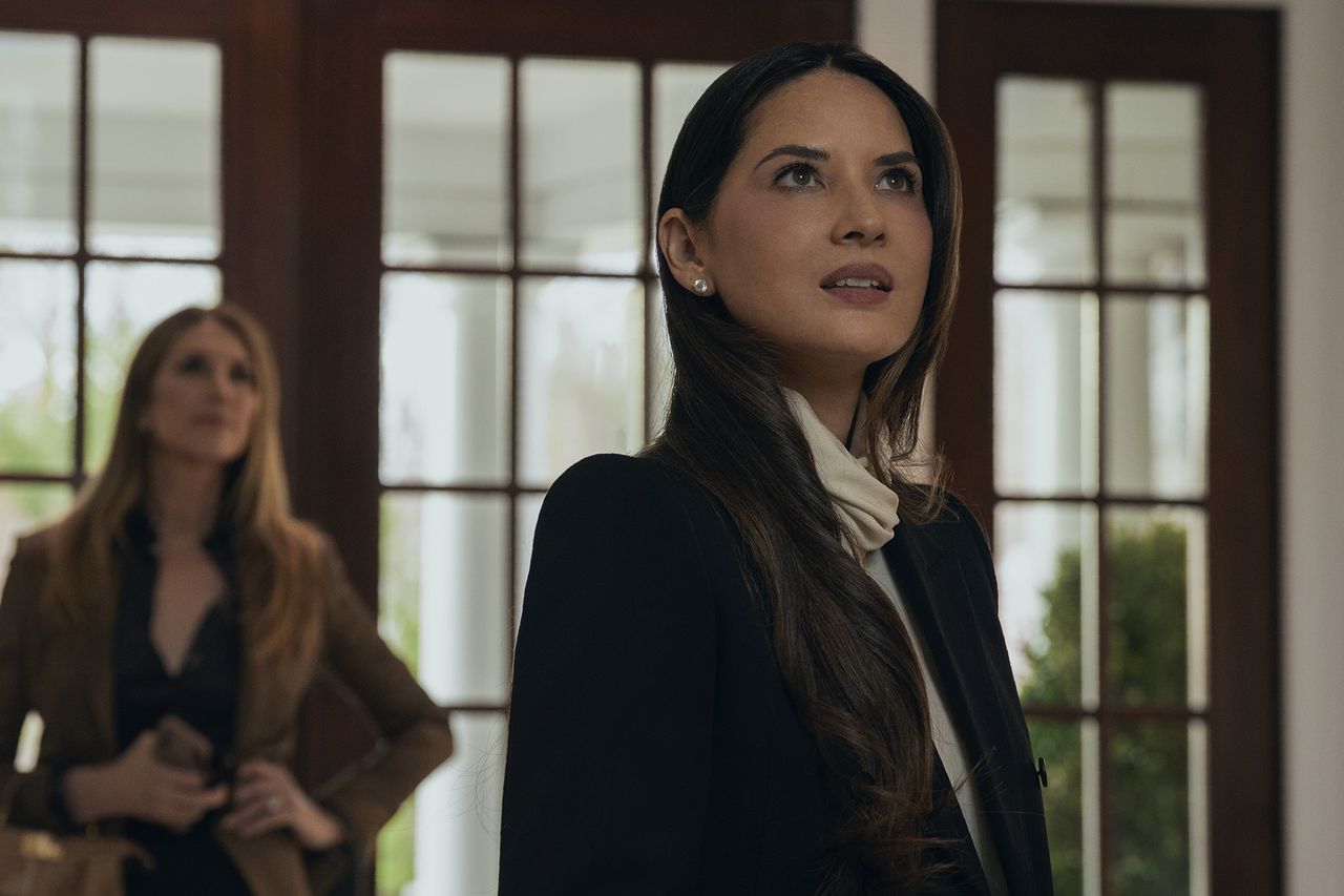Olivia Munn and Julie Claire standing indoors with a windows backdrop both looking in different directions Olivia Munn in 'Your Friends & Neighbors.'Credit: Apple TV