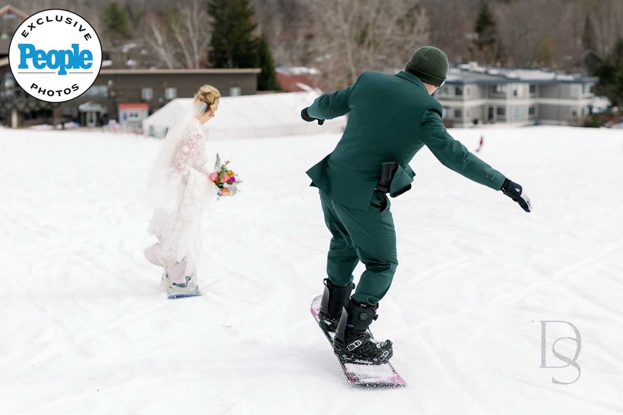 Lindsay & Rod snowboarding down after their ceremonyCredit: Dan Stewart Photography