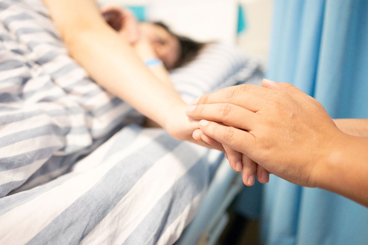 Holding patient's hand in hospital A patient in a hospital bed (stock image)Credit: getty
