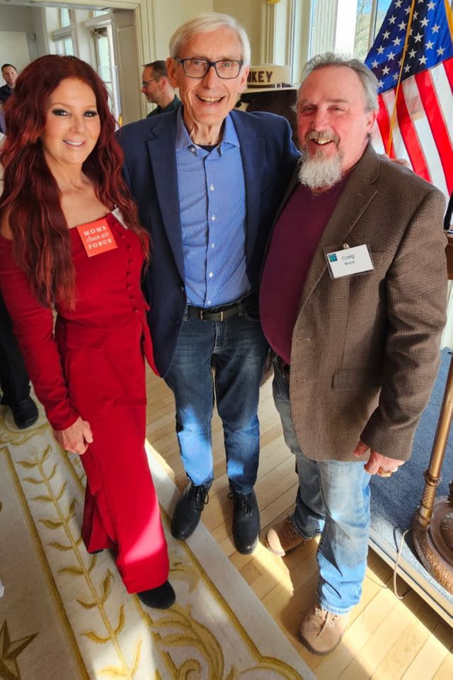 Jayne Black clean air activist. Jayne Black with Wisconsin Gov. Tony Evers (C) and her husband, Craig (R)Credit: Jayne Black
