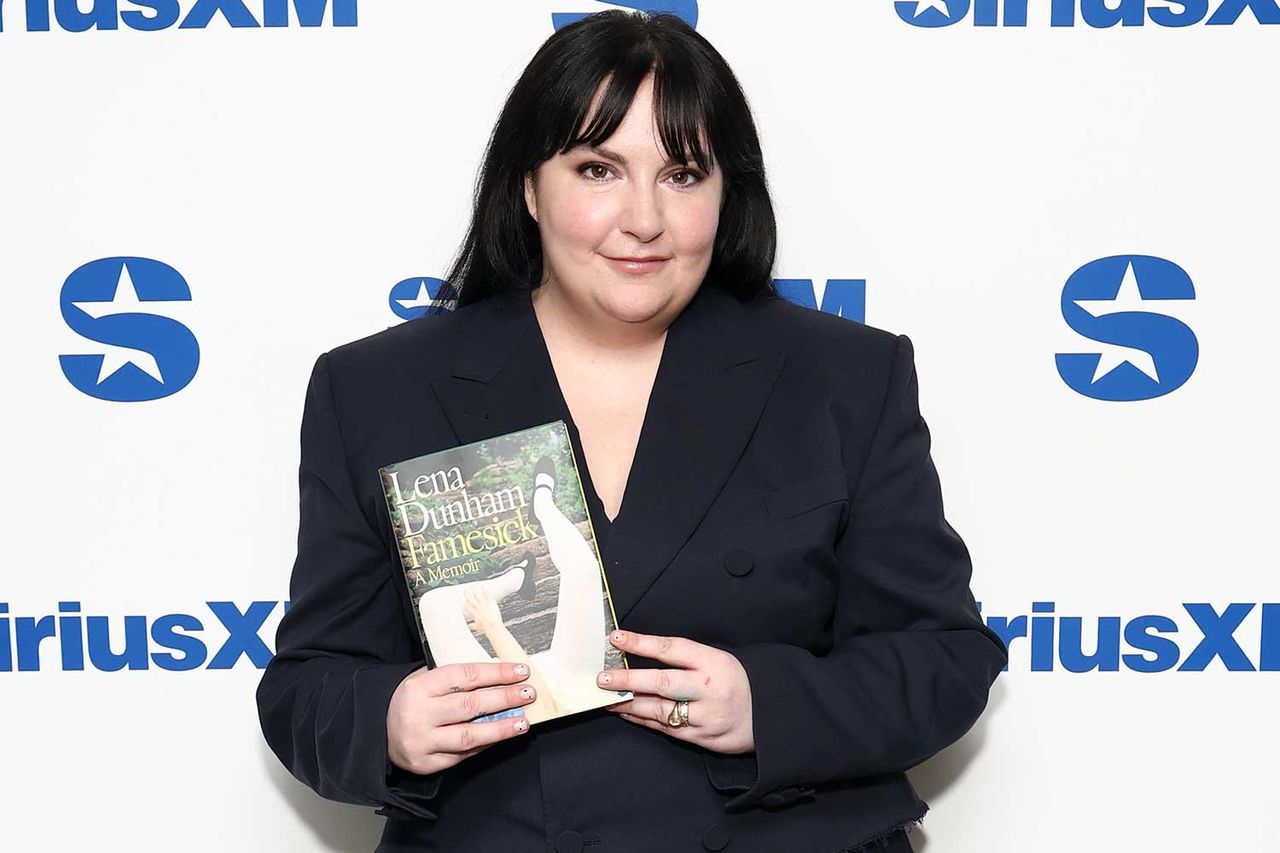 Lena Dunham holds up a copy of her memoir, 'Famesick', in April 2026Credit: Cindy Ord/Getty