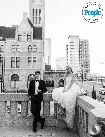 Couple in formal attire posing for a wedding photo on a city terrace Honor and Harper Bisagno's weddingCredit: Melina Massengill