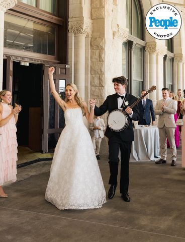 A bride and groom celebrating with the groom holding a banjo in a wedding setting Honor and Harper BisagnoCredit: Melina Massengill