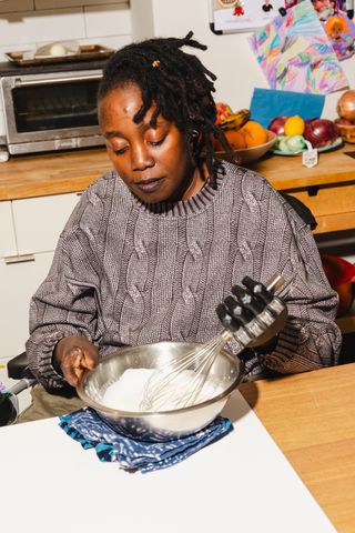 Yewande Komolafe Recipe Developer Learning How to Cook After After Losing Her Fingers and Legs Yewande Komolafe cooking in her kitchenCredit: Lanna Apisukh