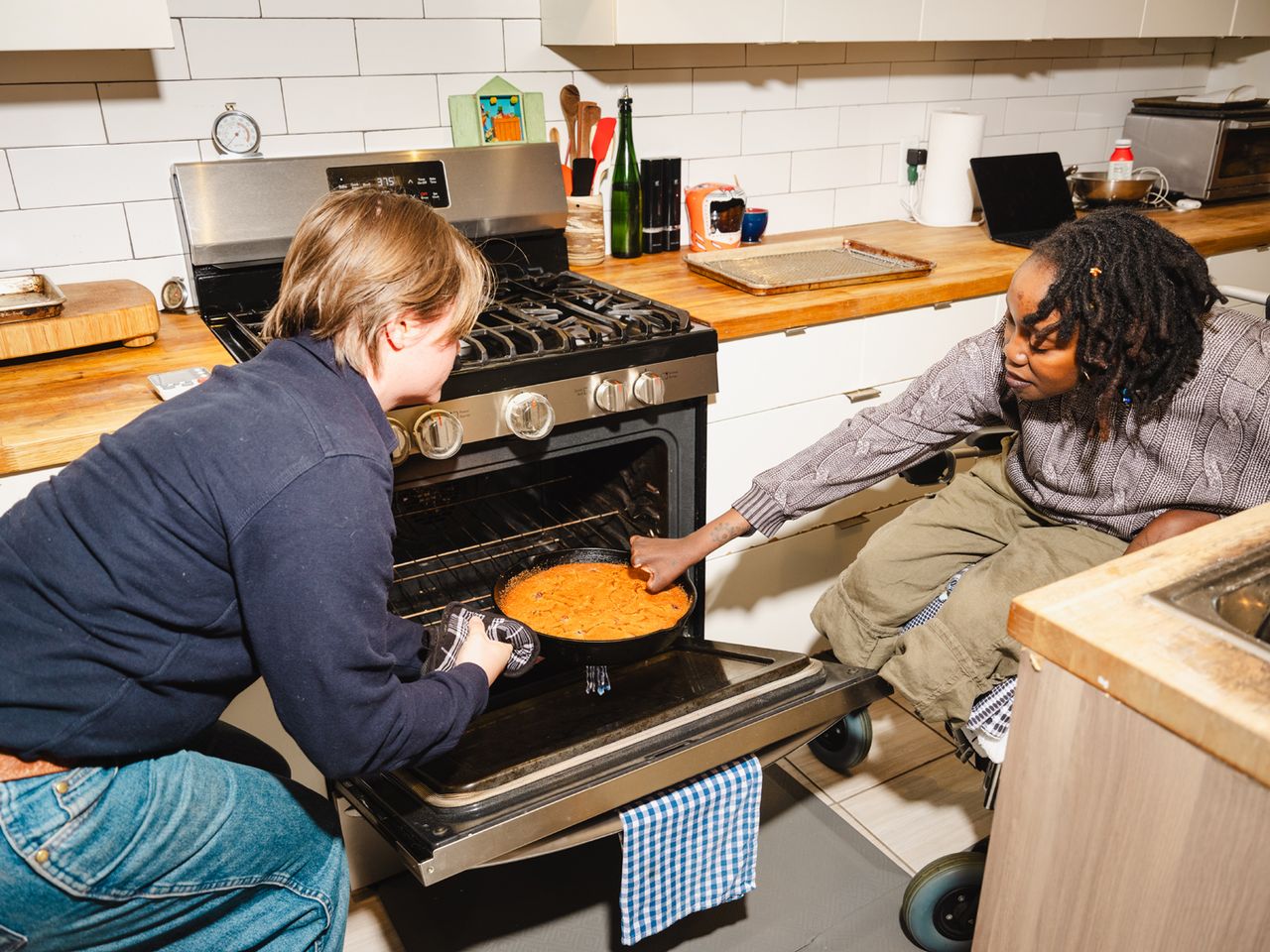 Yewande Komolafe Recipe Developer Learning How to Cook After After Losing Her Fingers and Legs Cooking assistant Stan De Tilly (L) and Yewande Komolafe (R) working together in her kitchenCredit: Lanna Apisukh
