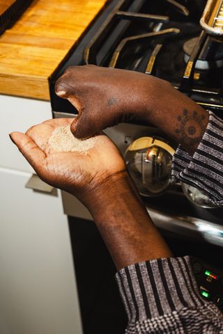 Yewande Komolafe Recipe Developer Learning How to Cook After After Losing Her Fingers and Legs Yewande Komolafe working with ingredients while developing a recipe in her kitchenCredit: Lanna Apisukh