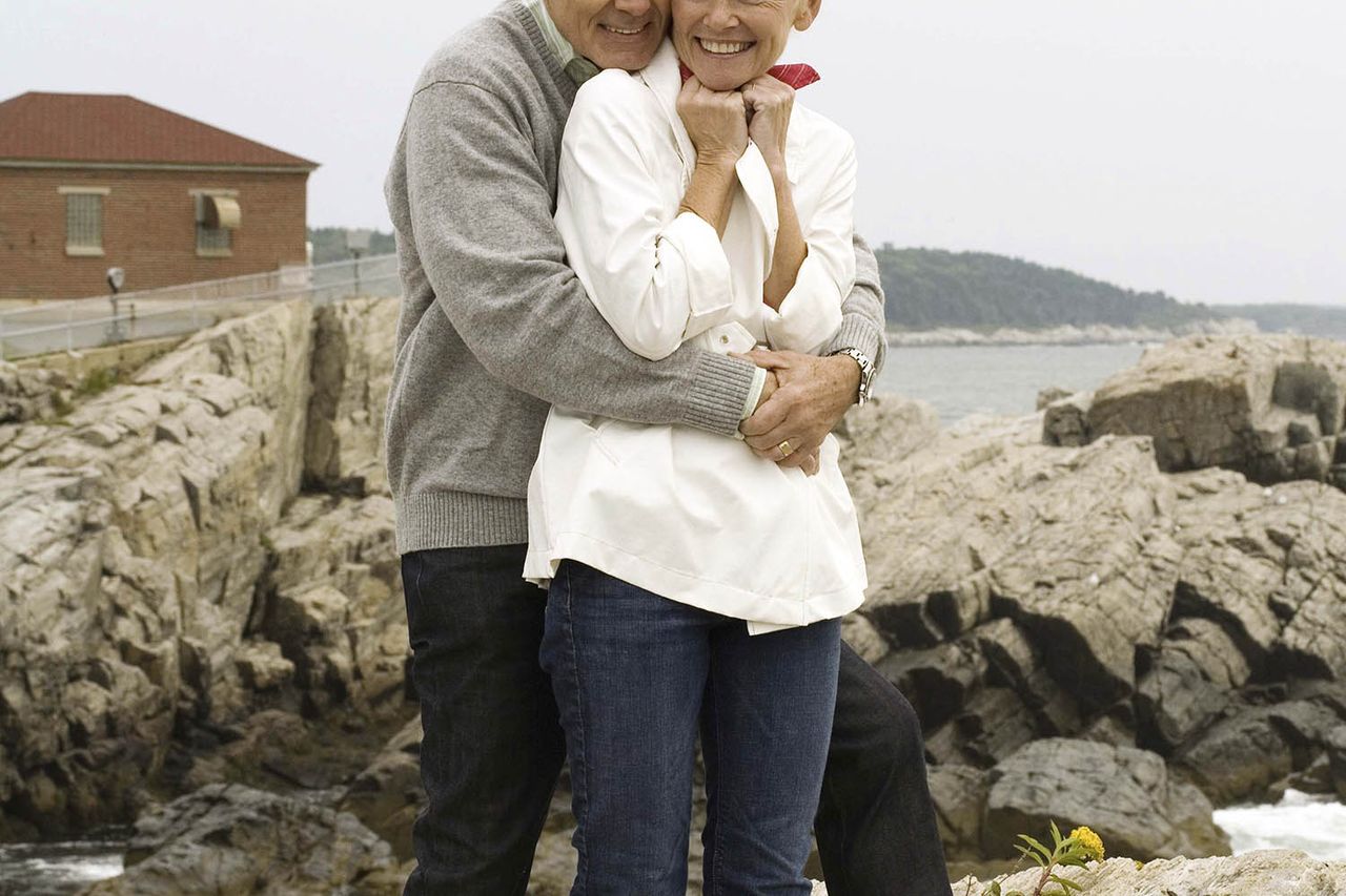 Couple embracing on rocks A tourist couple visits Portland, MaineCredit: Getty