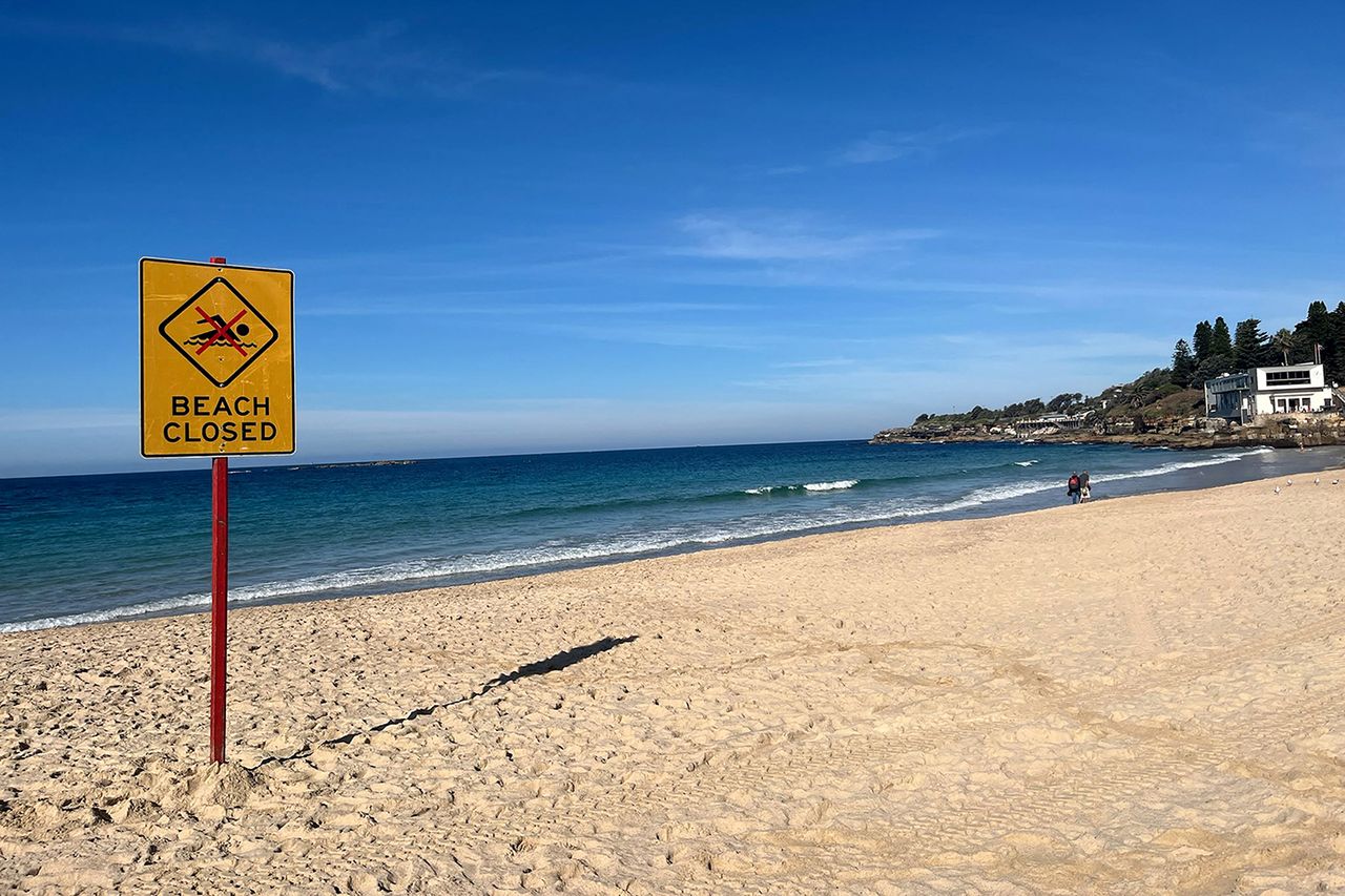 A beach closed sign at Coogee Beach in Sydney, AustraliaCredit: OLIVER HOTHAM / AFP via Getty