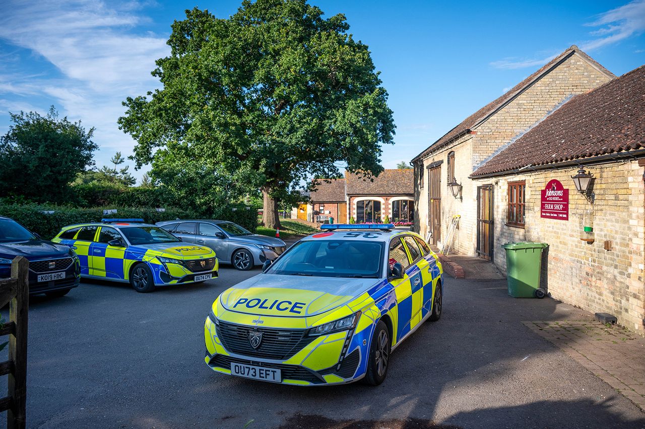 Police cars at Johnson of Old Hurst in England on Thursday, June 18Credit: SWNS