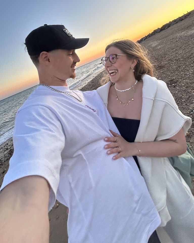 A couple embracing and smiling on a beach at sunset Jack Ellison and Heidi MontagueCredit: Kennedy News & Media