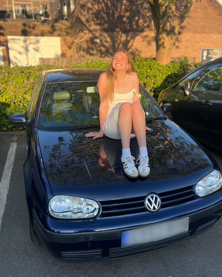 A woman sitting on the hood of a Volkswagen car in a parking lot Heidi Montague with her Volkswagen Polo BlueGTCredit: Kennedy News & Media