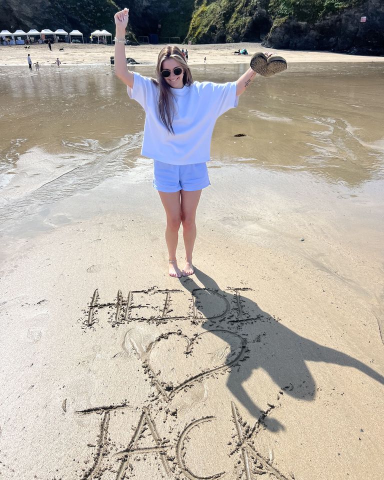 A woman standing on a beach with Heidi Jack drawn in the sand at her feet Heidi MontagueCredit: Kennedy News & Media