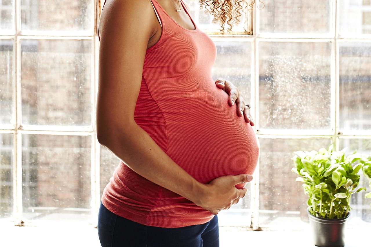 Stock image of a pregnant woman holding her bumpCredit: Getty