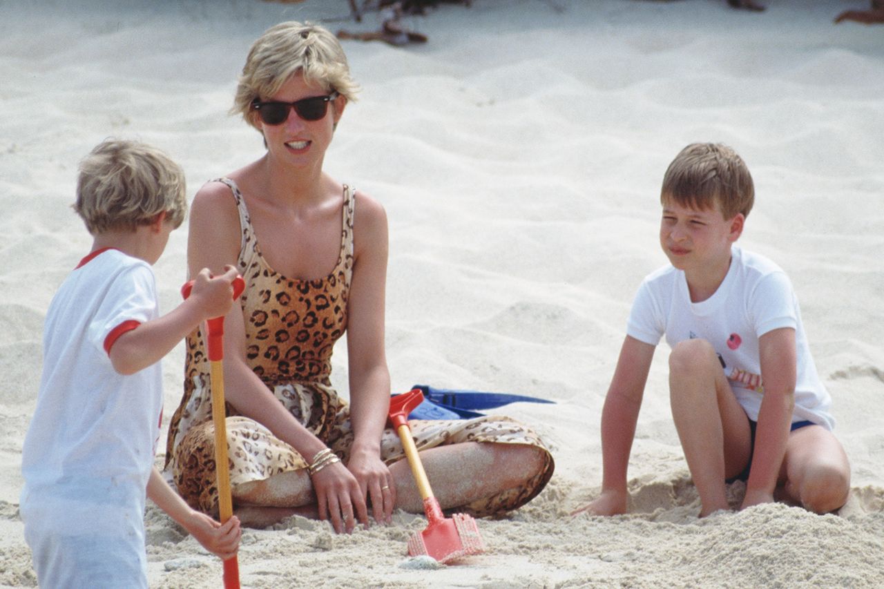 Diana, Princess of Wales (1961 - 1997) holidaying with her sons Prince William and Prince Harry and her sister's children on Necker Island in the British Virgin Islands, 11th April 1990. The island is owned by Virgin chairman Richard Branson. Diana is wearing a leopard print swimsuit while Prince William (second from right) buries her in sand. Princess Diana in 1990Credit: Tim Graham Photo Library via Getty
